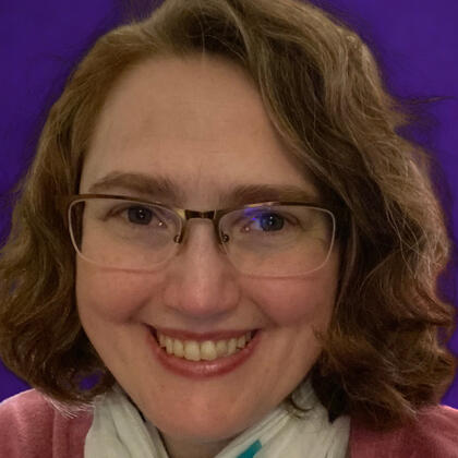 Diane Fulmer smiling with purple background
